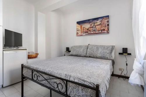 a bedroom with a bed and a flat screen tv at Appartamento Pescherie - Top location in Bologna