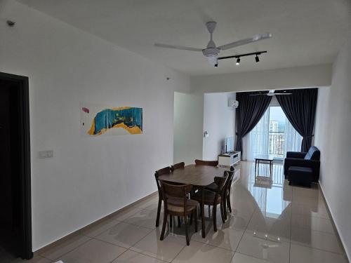 a dining room and living room with a table and chairs at METROPOL SERVICED APARTMENT at Bukit Mertajam, Pulau Pinang in Bukit Mertajam