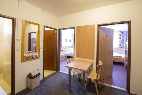a small dining room with a table and chairs at Rodinný penzion Skiland in Ostružná