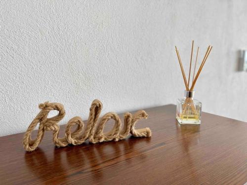 a wooden table with a glass vase and the word faith at REEF Beachfront 3BDR apartment by CASA PARAISO in Cancún
