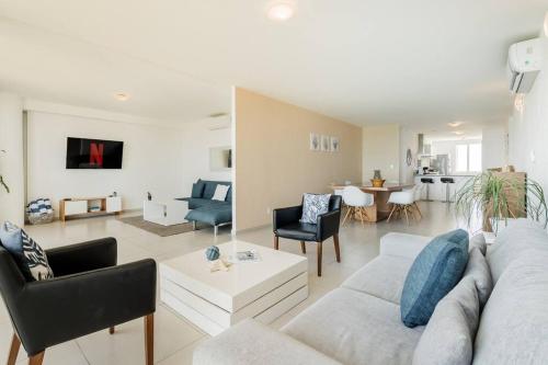 a living room with a couch and a table at REEF Beachfront 3BDR apartment by CASA PARAISO in Cancún