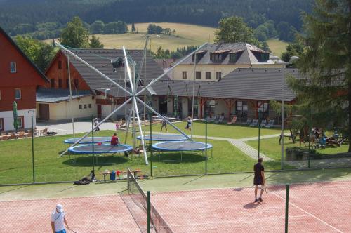 a group of people playing in a playground at Rodinný penzion Skiland in Ostružná