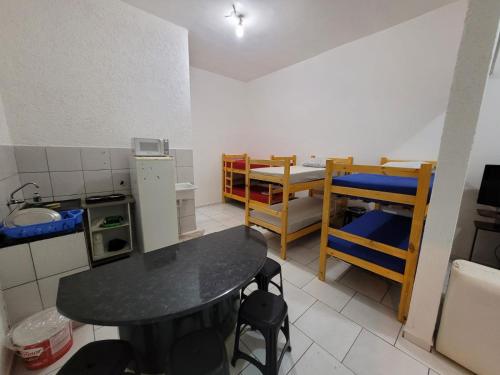 a small room with a table and a kitchen at apartamento ADE 101, wifi in Brasilia