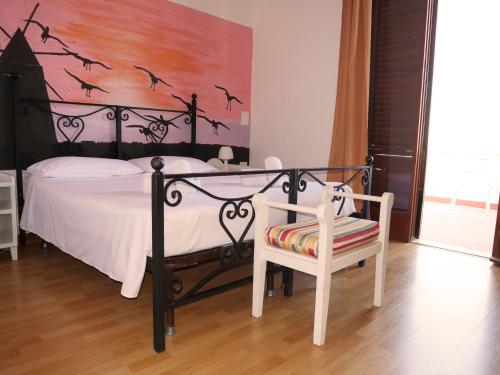 a bedroom with a bed with bats on the wall at B&B Al Vecchio Pontile Sea View in Marsala