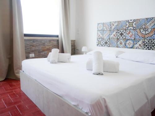 a large white bed in a room with a window at B&B Al Vecchio Pontile Sea View in Marsala