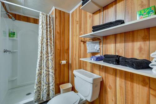 a bathroom with a white toilet and a shower at Eufaula Retreat Community Pool and Screened Porch! in Eufaula