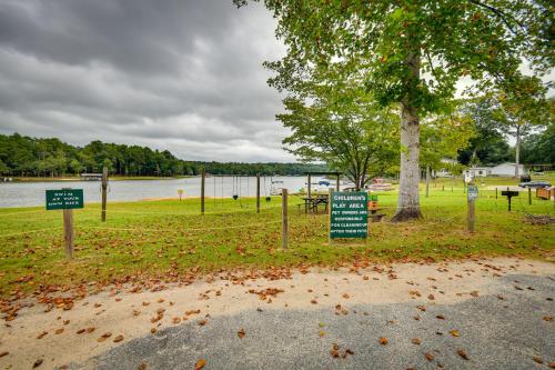 a park with signs in the grass next to a lake at Eufaula Retreat Community Pool and Screened Porch! in Eufaula