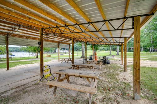 a group of picnic tables under a pavilion in a park at Eufaula Retreat Community Pool and Screened Porch! in Eufaula