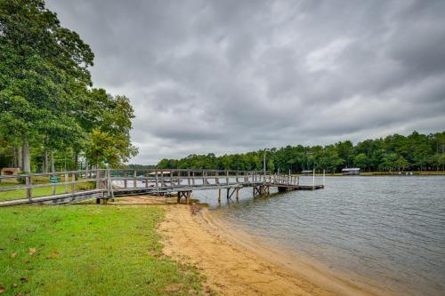 a dock on a body of water with trees at Eufaula Retreat Community Pool and Screened Porch! in Eufaula
