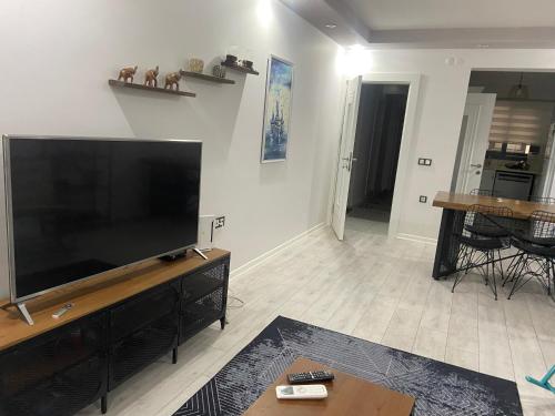 a living room with a large flat screen tv at M House at Karsiyaka in Karşıyaka