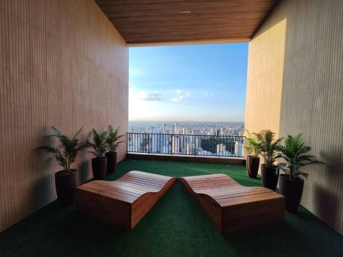 a balcony with two benches and a view of a city at ID Vida Urbana Setor Oeste Goiânia 3703A in Goiânia