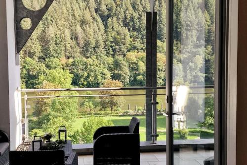 a room with a large window looking out at a green field at Penthouse mit Moselblick in Traben-Trarbach