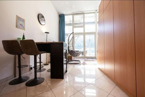 a room with a desk and chairs and a window at Penthouse mit Moselblick in Traben-Trarbach