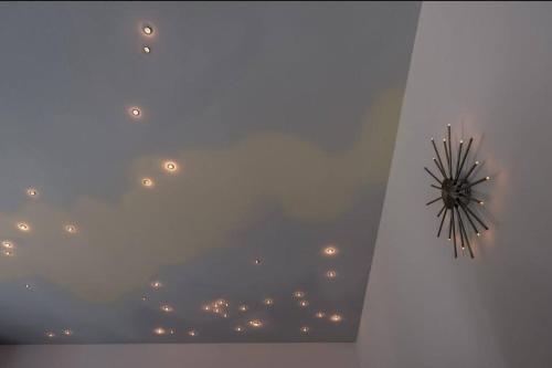 a clock on the ceiling of a room at Penthouse mit Moselblick in Traben-Trarbach