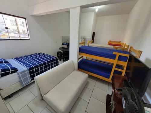 a bedroom with a bed and a couch and a table at apartamento ADE 101, wifi in Brasilia