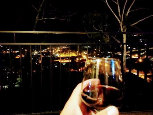 a hand holding a glass of wine at night at La Vista - Un lugar de Ensueño in Samaipata