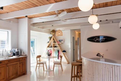 a kitchen and dining room with a table and chairs at Seaspray Surf Lodge in Vero Beach