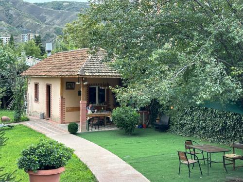 a small house with a table and chairs in a yard at GARRIOTT TBILISI in Tbilisi City