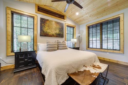a bedroom with a bed and a ceiling fan at Grill and Water Views Chinquapin Resort Home in Glenville