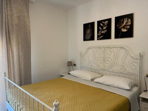 a bedroom with a bed with three pictures on the wall at Lovely Apartment in Parma