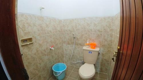 a bathroom with a toilet and a shower stall at Eltanin Homestay by FH Stay in Salakan