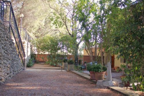 a garden with benches and trees and a building at il nuvoloso in Città della Pieve