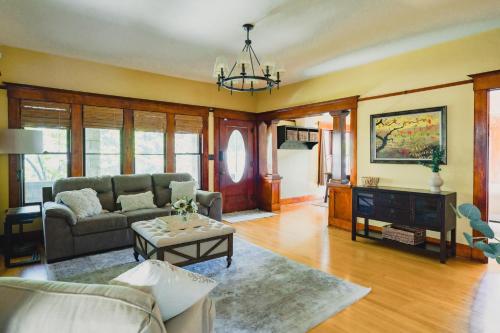 a living room with a couch and a table at 1907 Stone House - King Bed, Office, Crib, Toys in San Diego
