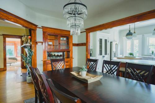 a dining room with a large wooden table and chairs at 1907 Stone House - King Bed, Office, Crib, Toys in San Diego