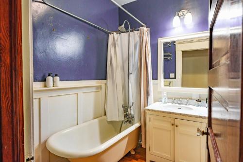 a bathroom with a tub and a sink and a bath tub at 1907 Stone House - King Bed, Office, Crib, Toys in San Diego