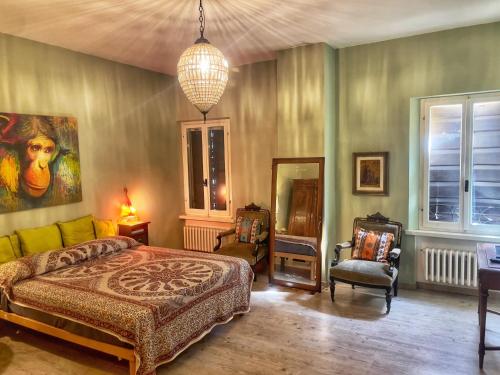 a bedroom with a bed and a pendant light at A Casa di Maica in Gualdo