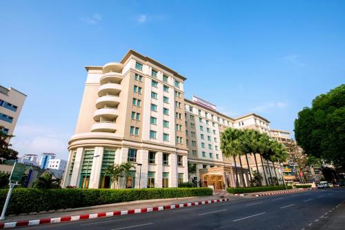 a large white building on the side of a street at PARKROYAL Yangon in Yangon