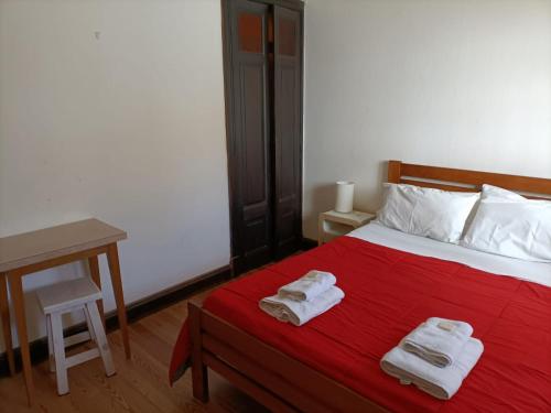 a bedroom with a bed with two towels on it at Casa Nanet Hotel in Mar del Plata