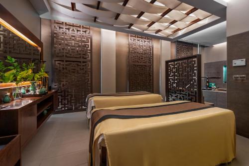 a room with three beds in a room with at Palácio Estoril Hotel, Golf & Wellness in Estoril