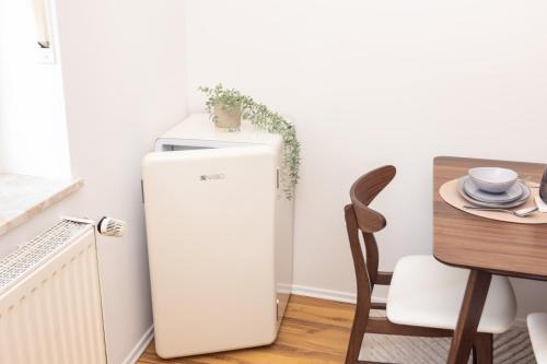 a white refrigerator in a kitchen next to a table at #2 SUPERIOR! Nespresso - Küche - Prime - Parken in Duisburg