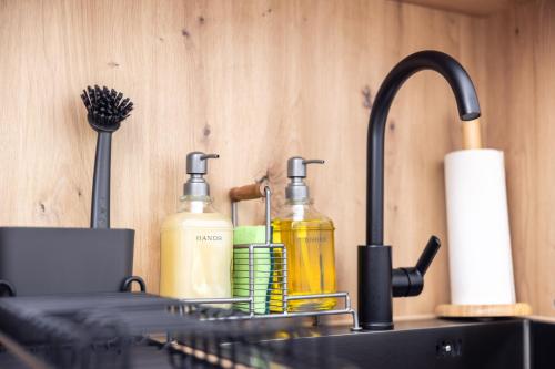 a sink with two bottles of soap and aaucet at #2 SUPERIOR! Nespresso - Küche - Prime - Parken in Duisburg