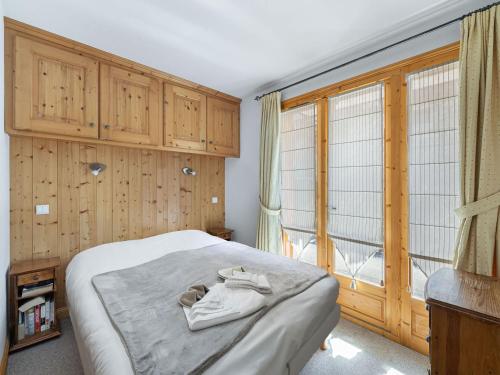 a bedroom with a bed and a large window at Chalet familial cosy pour 8 pers. près des pistes et commodités à Courchevel Le Praz - FR-1-568-44 in Courchevel