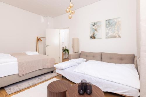 a bedroom with two beds and a table at #2 Superior! Nespresso - Küche - Prime - Parken in Duisburg