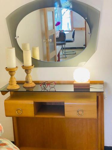 a mirror on top of a wooden dresser in a room at La Casita a 60 pasos del mar in Tamaduste