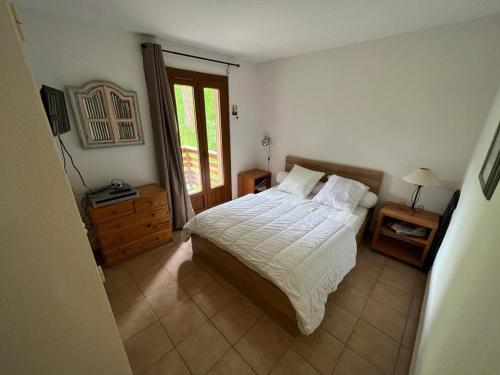 a bedroom with a large bed and a window at Appartement Les Angles, 3 pièces, 6 personnes - FR-1-593-93 in Les Angles