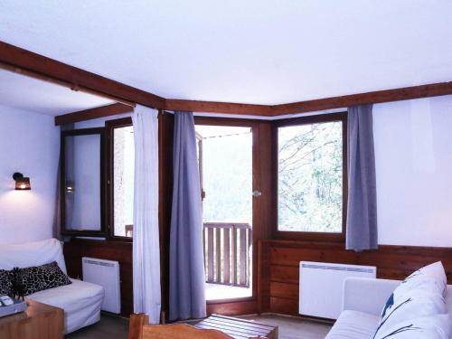 - un salon avec un canapé et des fenêtres dans l'établissement Studio skis aux pieds, 6 pers, cheminée, billard, WIFI, centre Les Orres - FR-1-322-534, aux Orres