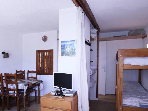 Cette chambre comprend un bureau avec un ordinateur et un lit. dans l'établissement Studio skis aux pieds, 6 pers, cheminée, billard, WIFI, centre Les Orres - FR-1-322-534, aux Orres