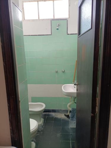 a bathroom with two toilets and a sink at Casa Nanet Hotel in Mar del Plata