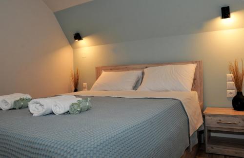a bedroom with a bed with towels on it at Meteora's unique gem in Kastrákion