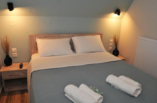 a bedroom with a bed with two towels on it at Meteora's unique gem in Kastrákion