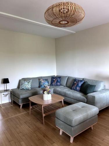 a living room with a couch and a table at Gîte Bois Tordu - 3 chambres - proche Bourganeuf in Montboucher