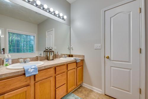 a bathroom with two sinks and a large mirror at Inviting Austell Home 14 Mi to Downtown Atlanta! in Austell