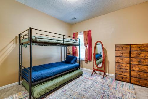 a bedroom with two bunk beds and a mirror at Inviting Austell Home 14 Mi to Downtown Atlanta! in Austell