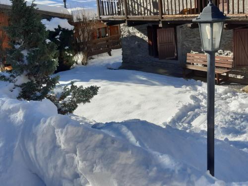 a pile of snow next to a street light at Sauze d'Oulx ciabot la garitüla with garden - wifi- close to the chairlift in Sauze dʼOulx