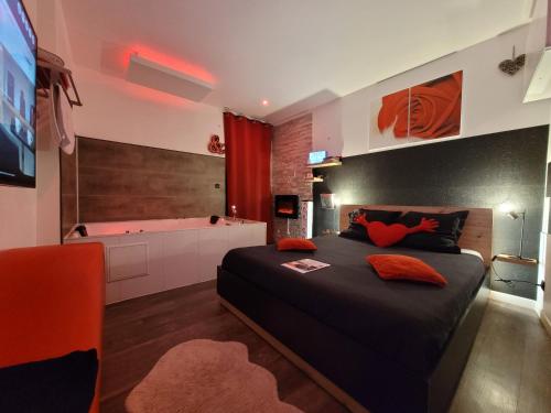 a bedroom with a large bed and a bath tub at Love & Spa in Avignon