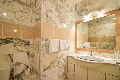 a bathroom with a sink and a mirror at Hôtel-Restaurant Le Lac in Malbuisson